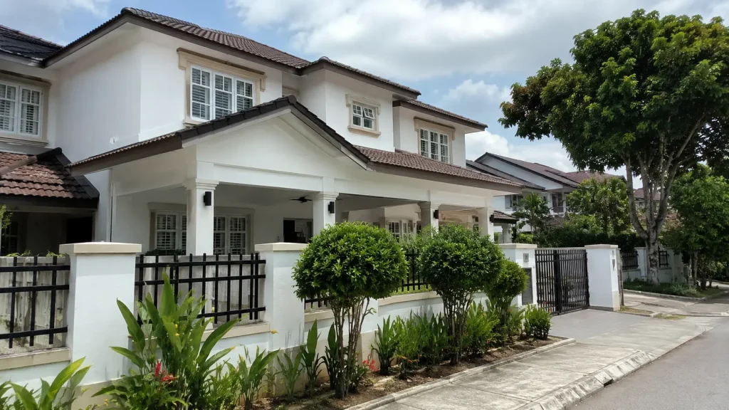 Freshly painted exterior of a Malaysian double-storey terrace house with clean white walls and neat trim